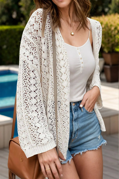 Model wearing Openwork Open Front Dropped Shoulder Cardigan over a tank top and shorts by a poolside.
